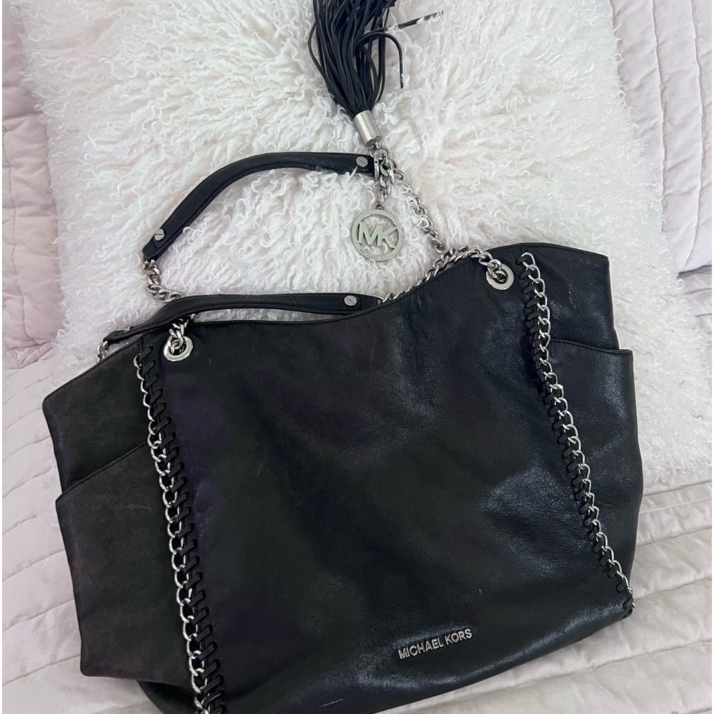 Michael Kors  black purse with metal chain accent with two side pockets.